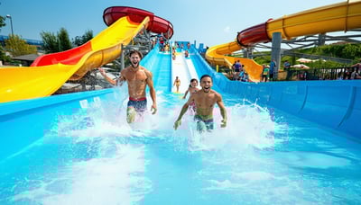 Families enjoying a vibrant water park on a sunny day Families enjoying a vibrant water park on a sunny day